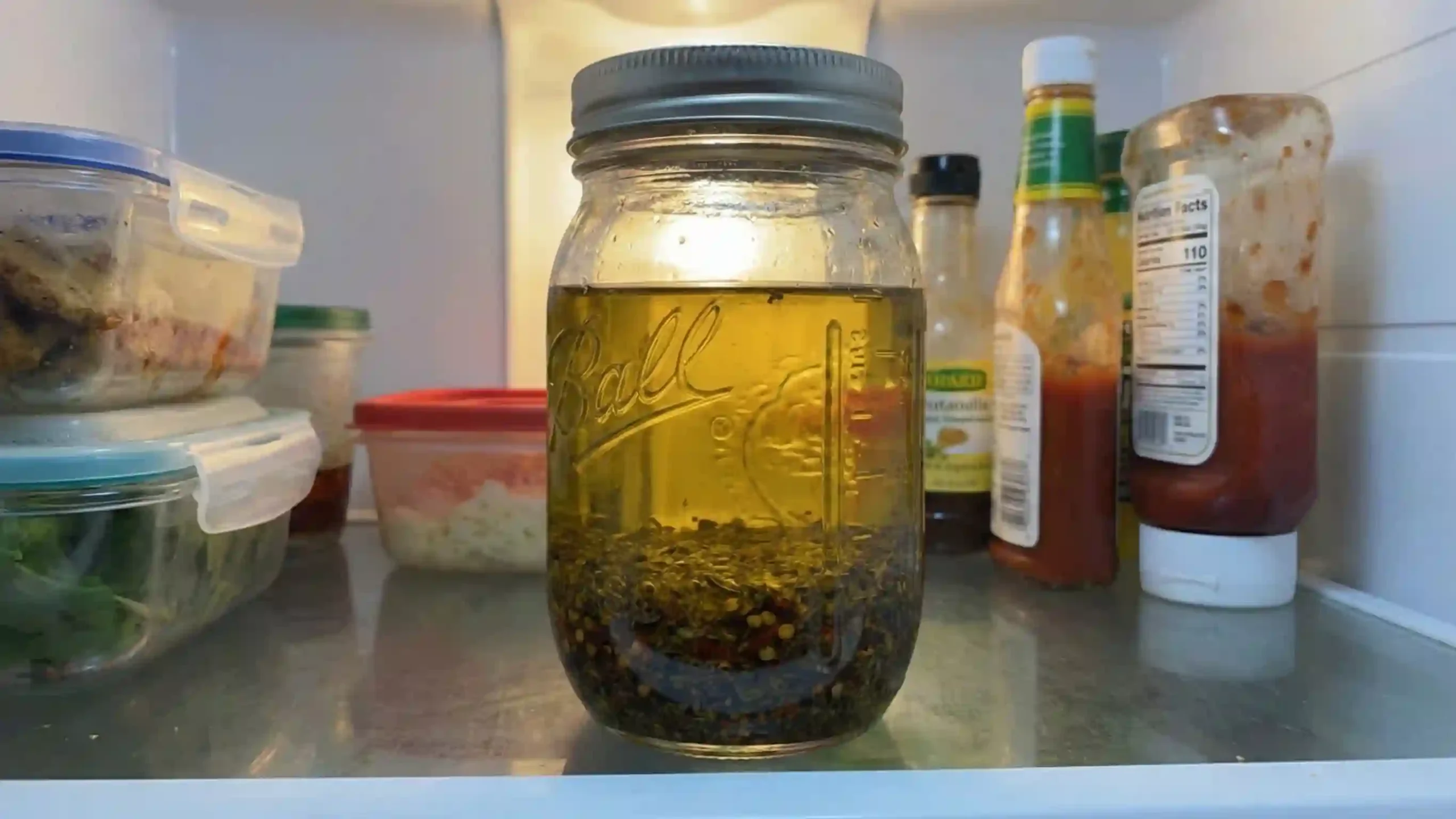 Homemade sub oil stored in glass jar showing oil separation
