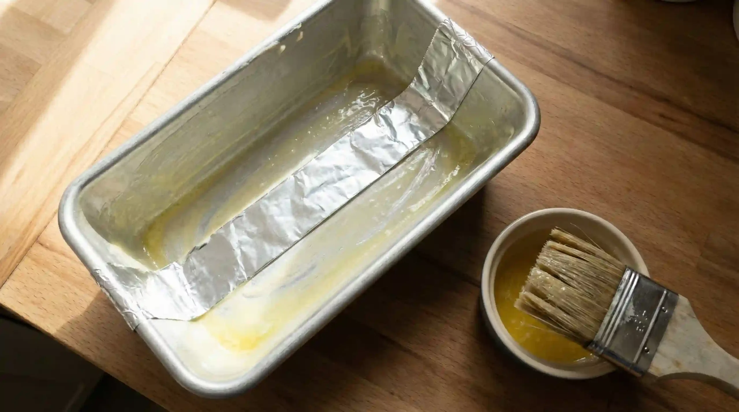 Greased loaf pan with a foil strip for lifting the loaf out cleanly