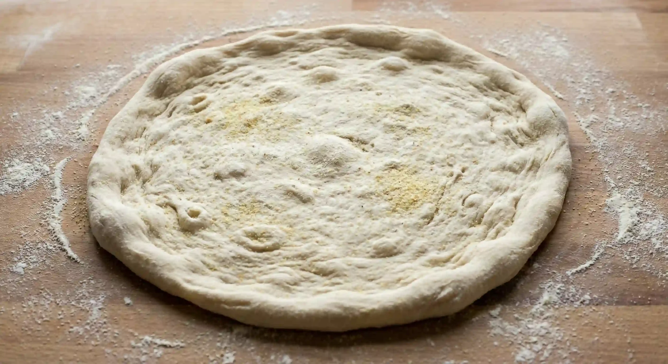 Pizza dough stretched with a clear crust border ready for topping